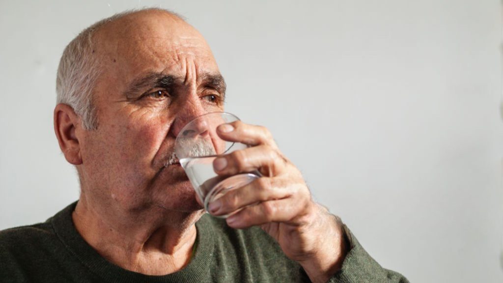 Drinking water to stay hydrated and help reduce snoring