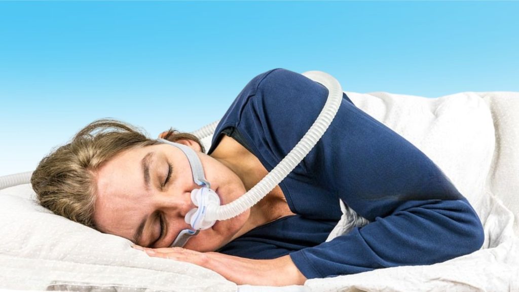 Woman sleeping with CPAP therapy for sleep disorder treatment